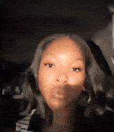 a close up of a woman 's face with a shadow on it .