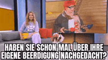 a woman is sitting on a couch in front of a television with a picture of a woman .