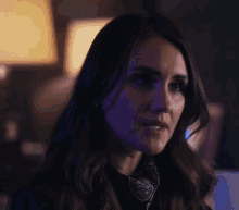 a close up of a woman 's face in the dark