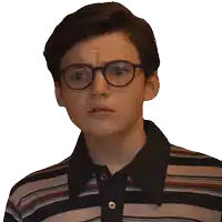 a young boy wearing glasses and a striped shirt makes a funny face