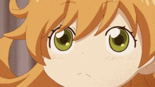 a close up of a girl 's face with green eyes and orange hair