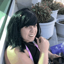 a woman wearing a purple lanyard that says ' sdg ' on it