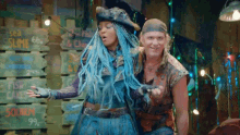 a woman with blue hair is standing next to a man