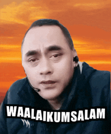 a man wearing a headset with the words waalaikumsalam written above him