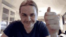 a man with a mustache gives a thumbs up
