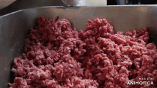 a close up of a pile of ground meat with the words made in animotica visible