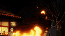 a group of people standing in front of a burning building