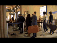 a group of people are standing in front of a sign that says claim
