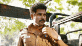 a man in a police uniform has a name tag on his chest that says ' a.s. '