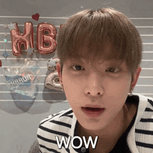 a close up of a person 's face with the word wow in front of him