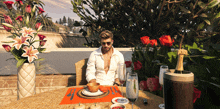 a man sits at a table with a bottle of moet on it