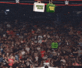a woman in a wrestling ring with a sign that says raw