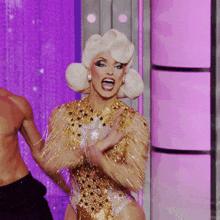 a woman in a gold leotard with stars on it is dancing
