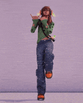a girl wearing headphones and a green sweater is giving the middle finger