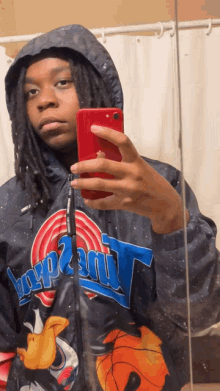 a person taking a selfie with a space jam jacket