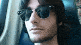 a man wearing a pair of ray-ban sunglasses