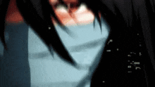 a close up of a person 's face with a blurry background and a blue shirt .