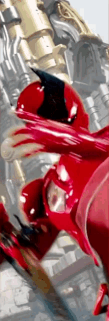 a close up of a person in a red superhero suit