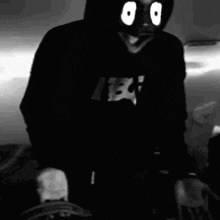 a black and white photo of a person wearing a mask .