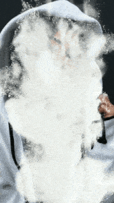 a person wearing a white hoodie is covered in white powder