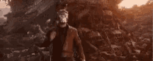 a man is standing in front of a large explosion with the words `` boom '' written on the bottom .