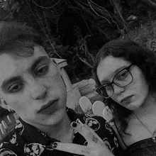 a black and white photo of a man and a woman standing next to each other