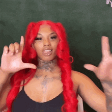 a woman with red hair and a tattoo on her neck is making a hand gesture