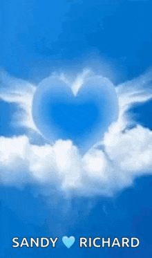 a blue heart with white wings is surrounded by white clouds in the sky .