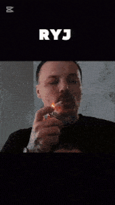 a man with a tattoo on his arm is smoking a cigarette with the caption ryj above him