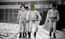 a group of men are walking down a sidewalk and one of them has a purple hat on