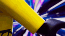 a close up of a person 's arm with a yellow object in the background