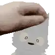 a person is petting a cartoon character 's head with their hand .