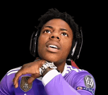 a man wearing headphones and a purple shirt with fifa on it
