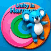 a blue teddy bear is standing on a colorful circle that says unity in harpoon