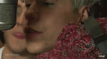 a close up of a person singing into a microphone with the words wb channel visible