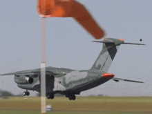 a military plane is taking off from an airport runway