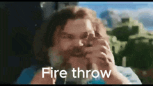 a man with a beard is holding a fire thrower in his hand .
