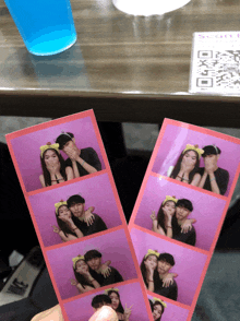 a person is holding a pair of pink photo strips with a blue drink in the background