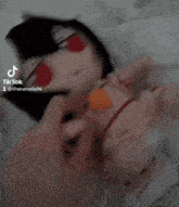 a person is petting a stuffed doll that has red eyes
