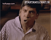 a man in a striped shirt is making a surprised face