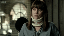 a woman with a police lanyard around her neck looks at the camera