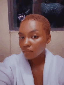 a woman with short red hair has a cute heart on her head