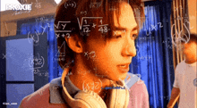 a man wearing headphones is surrounded by mathematical equations including x + y