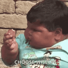 a fat boy is eating a piece of ice cream .