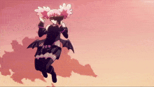 a girl in a bat costume is flying in the sky
