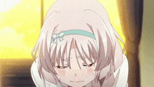 a girl with a bow in her hair is crying with her eyes closed
