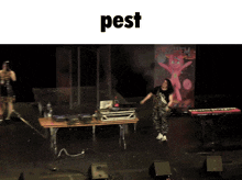 a woman is dancing on stage with the word pest above her