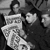a group of soldiers are reading a newspaper with the headline benjamins dead