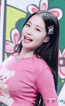 a woman wearing a pink shirt that says love