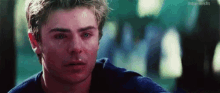 a close up of a man 's face with a tear running down his cheek .